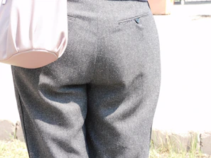 Charcoal grey slim-fit formal pants displayed with sharp focus on fabric weave, set against a crisp white backdrop.
