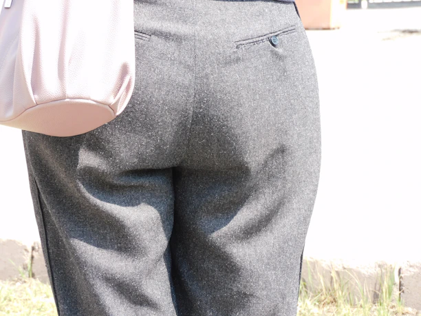 Close-up of a man wearing charcoal grey regular fit formal pants, highlighting the fabric texture and fit.