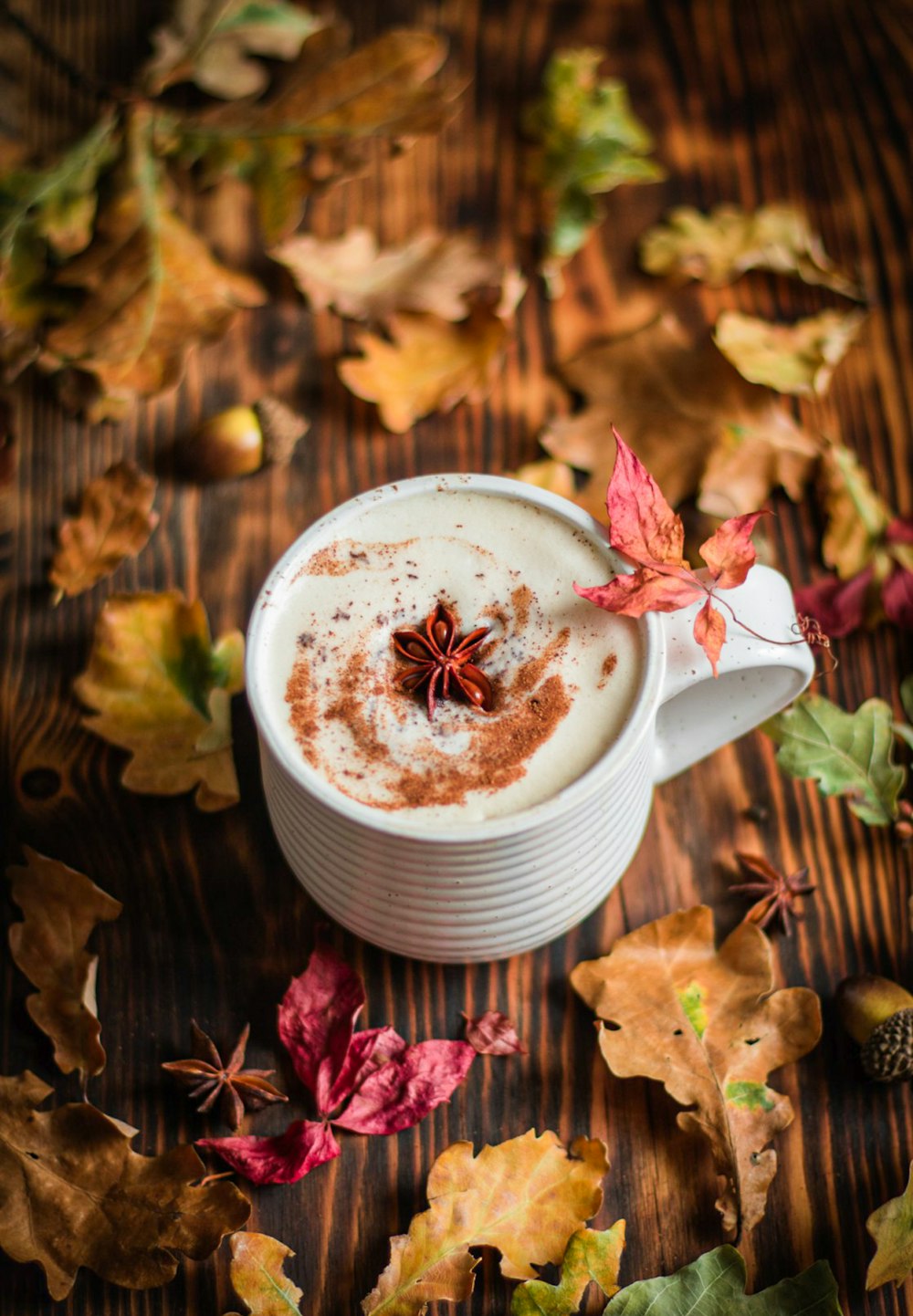 a cup of hot chocolate with cinnamon on a wooden table