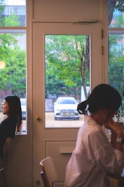 A serene scene of two people having a heartfelt conversation in a cozy, sunlit room.