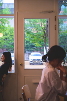 A warm consultation scene with a family discussing finances by a window overlooking the sea.