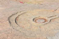 Symbolic motifs etched into a medieval artifact, highlighting cultural meanings.