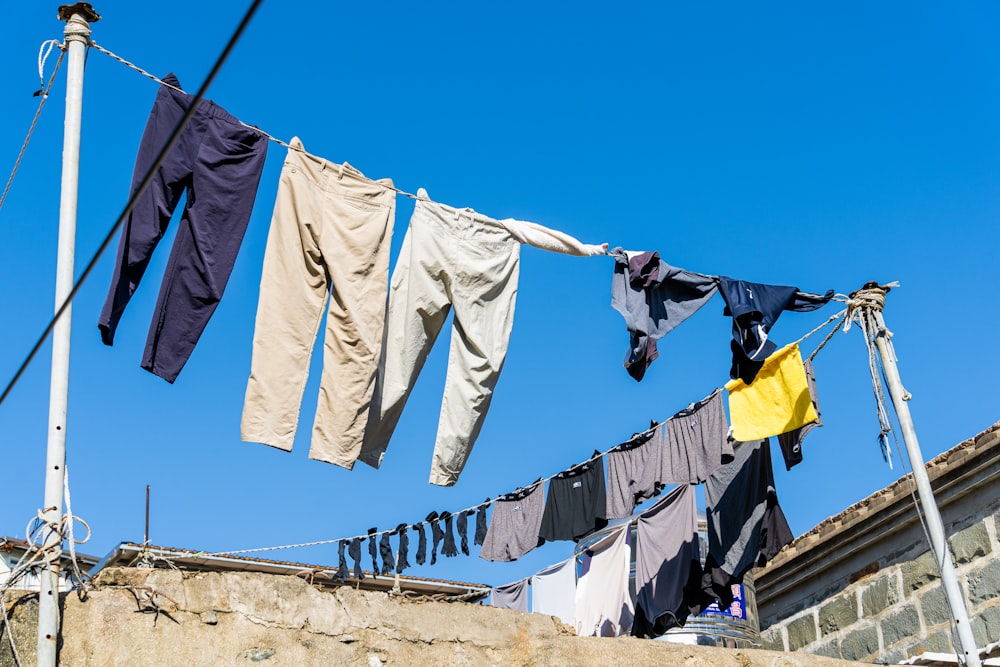 clothes hanging on a clothes line with a blue sky in the background