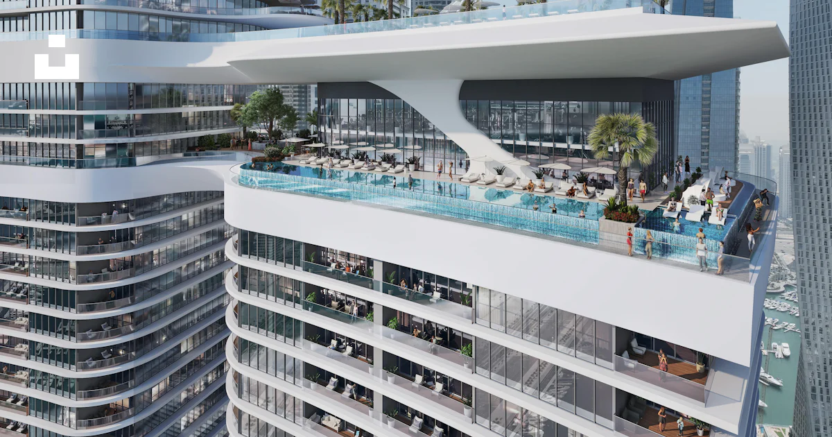 A very tall building with a pool in the middle of it photo – Free Dubai ...