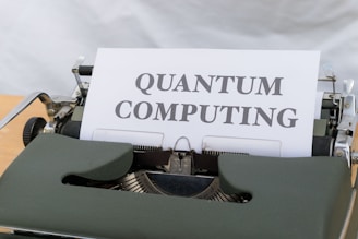 A green vintage typewriter holding a sheet of paper with the words 'Quantum Computing' typed in bold letters.