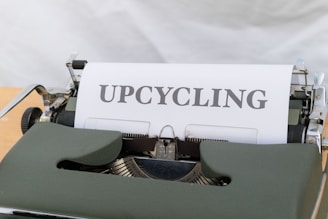a close up of a typewriter with the word upcycling on it