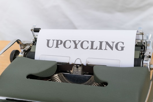 a close up of a typewriter with the word upcycling on it