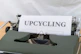 a close up of a typewriter with the word upcycling on it