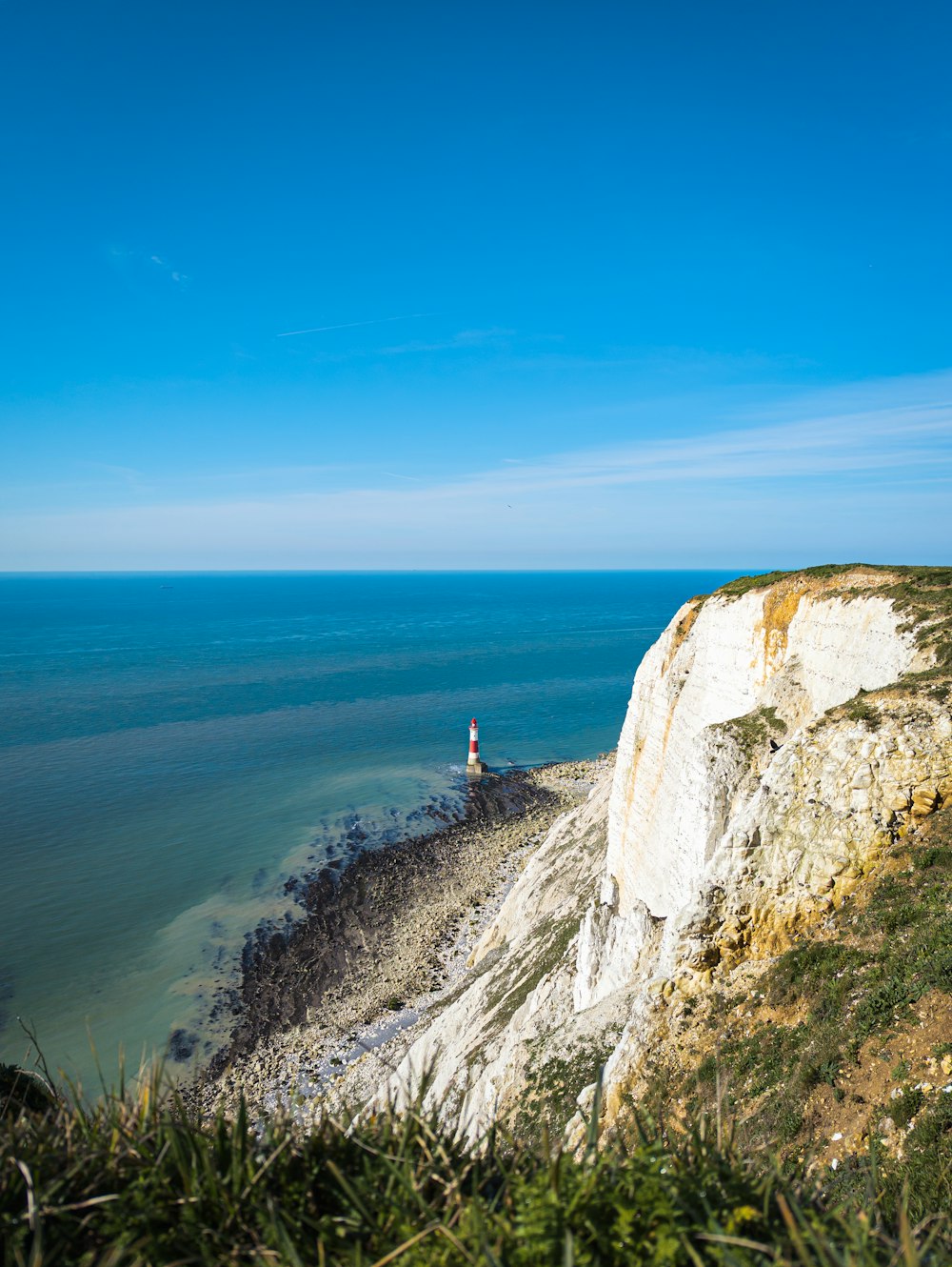 a lighthouse on a cliff overlooking the ocean