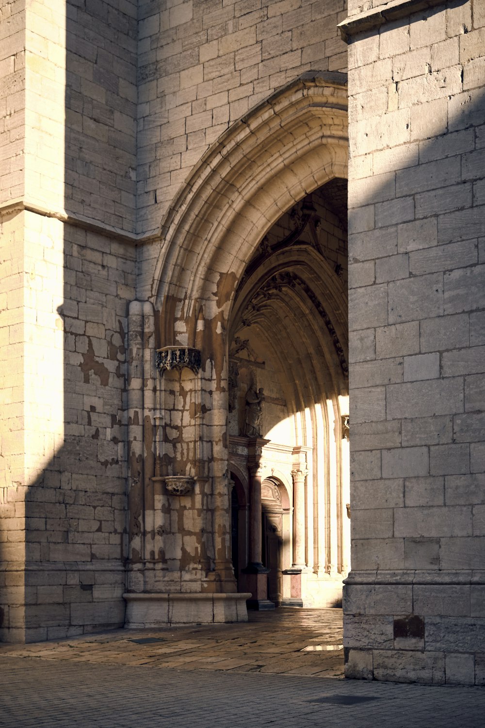 a large stone building with a clock on it's side