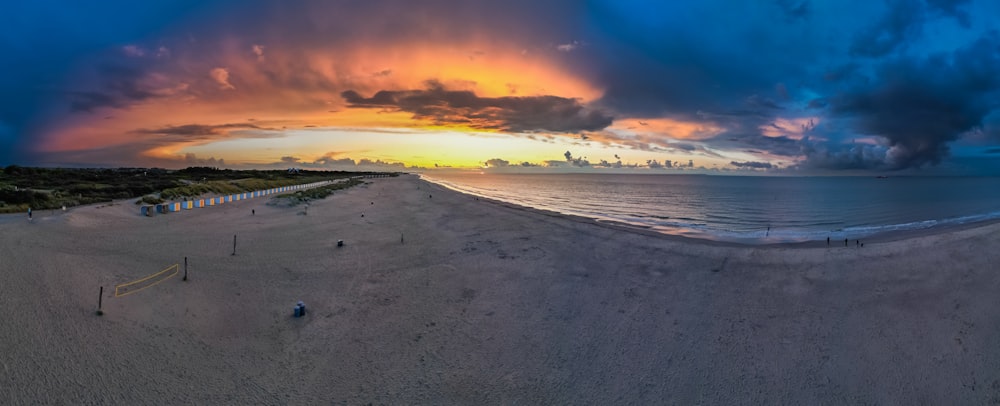 a beautiful sunset over the ocean with clouds