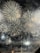 A spectacular display of large fireworks illuminating the night sky with bursts of bright, colorful lights and smoke. The fireworks create intricate patterns with golden and white hues, adding a sense of festivity and celebration.