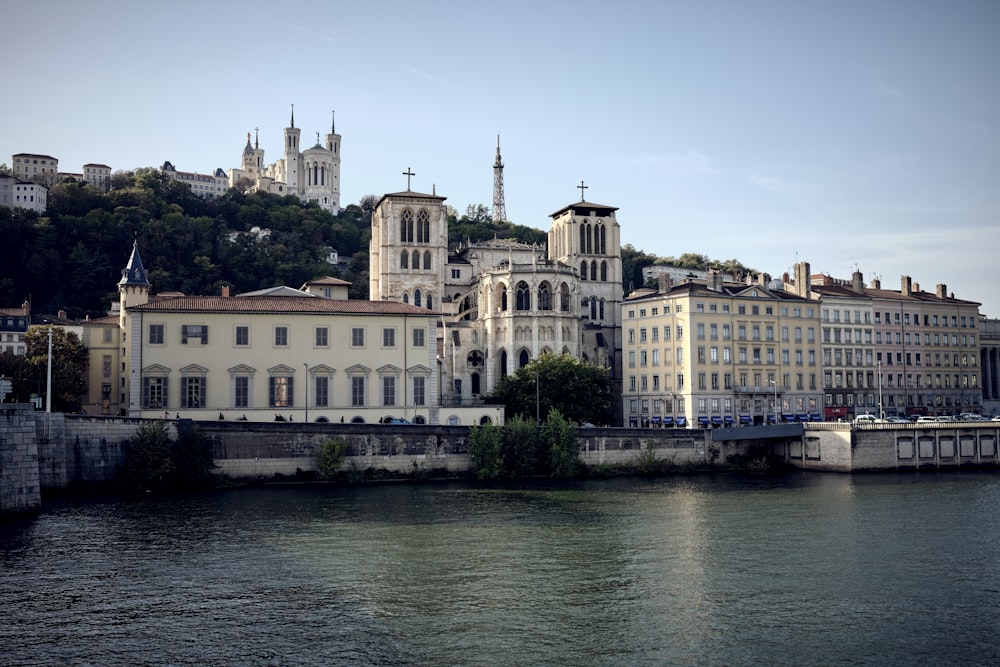 a river with buildings and a bridge in front of it