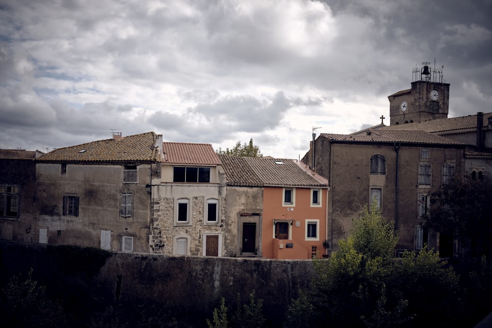 a row of buildings with a clock tower in the background