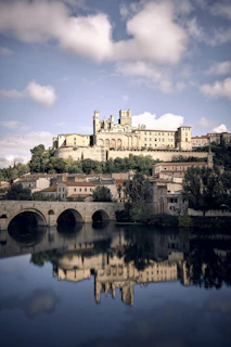 a castle on top of a hill next to a body of water