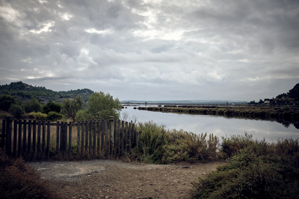 a body of water surrounded by a wooden fence