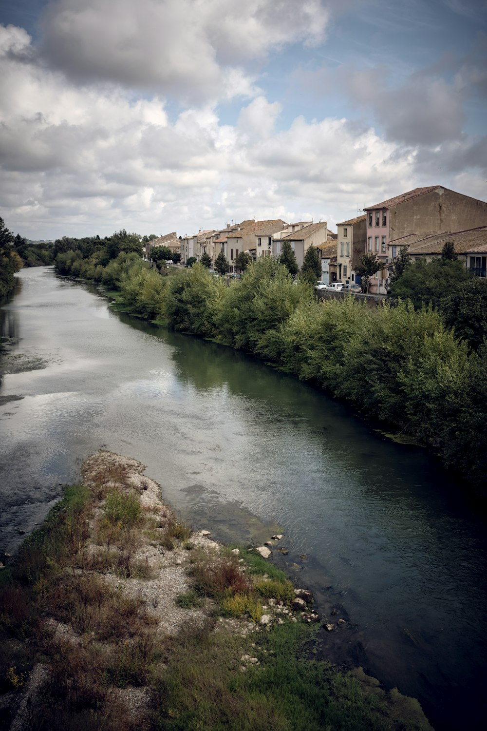 a river running through a lush green countryside