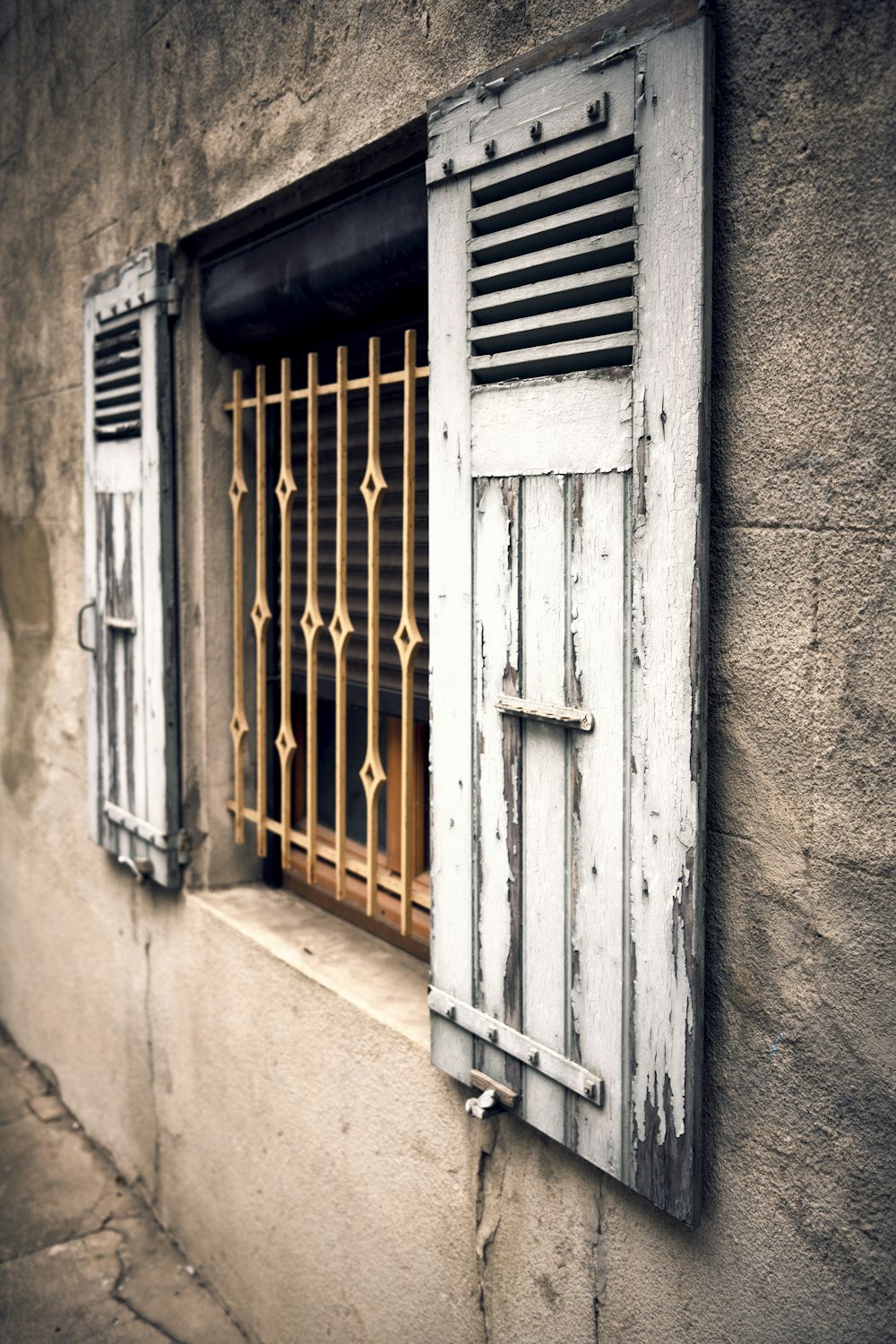 a window with bars on the side of a building