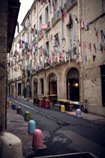 Cozy cobbled alleyway in Tirana's center adorned with vibrant street art and quaint cafes.