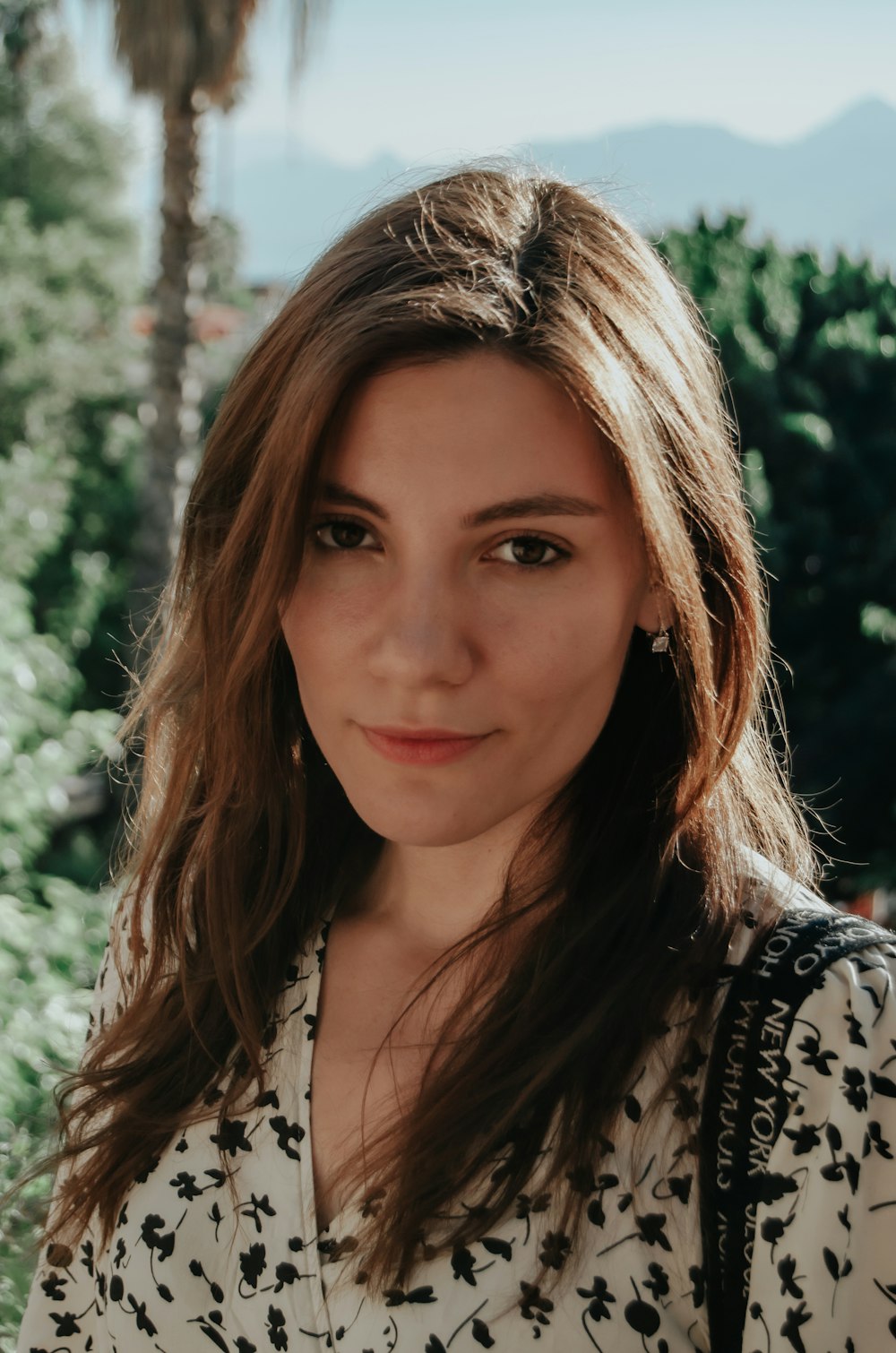 a woman with long hair wearing a white shirt