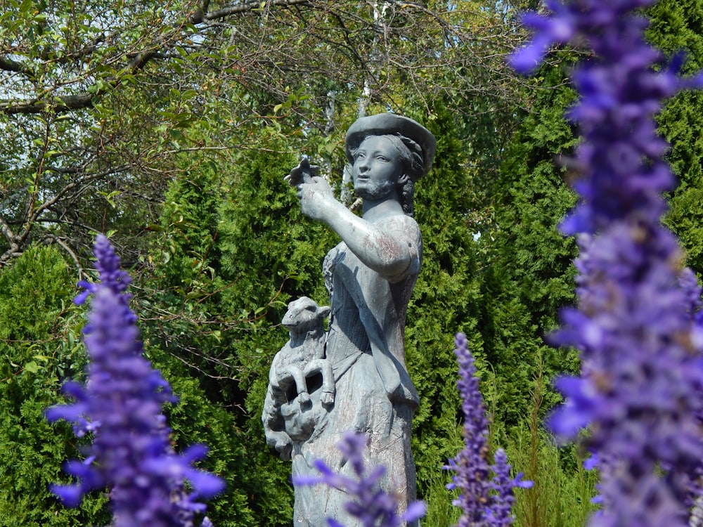 a statue of a woman holding a bird in her hand