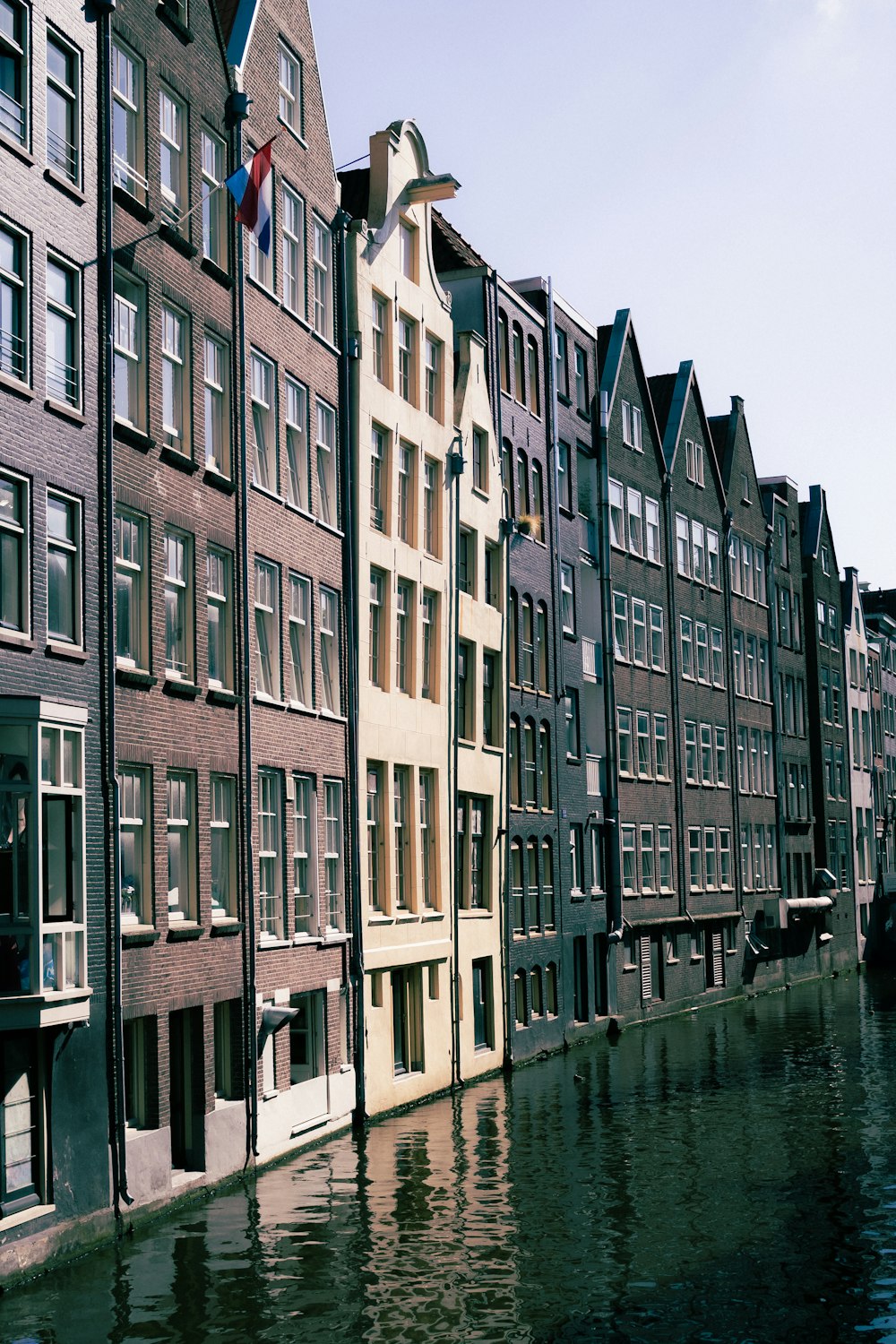 a row of buildings next to a body of water