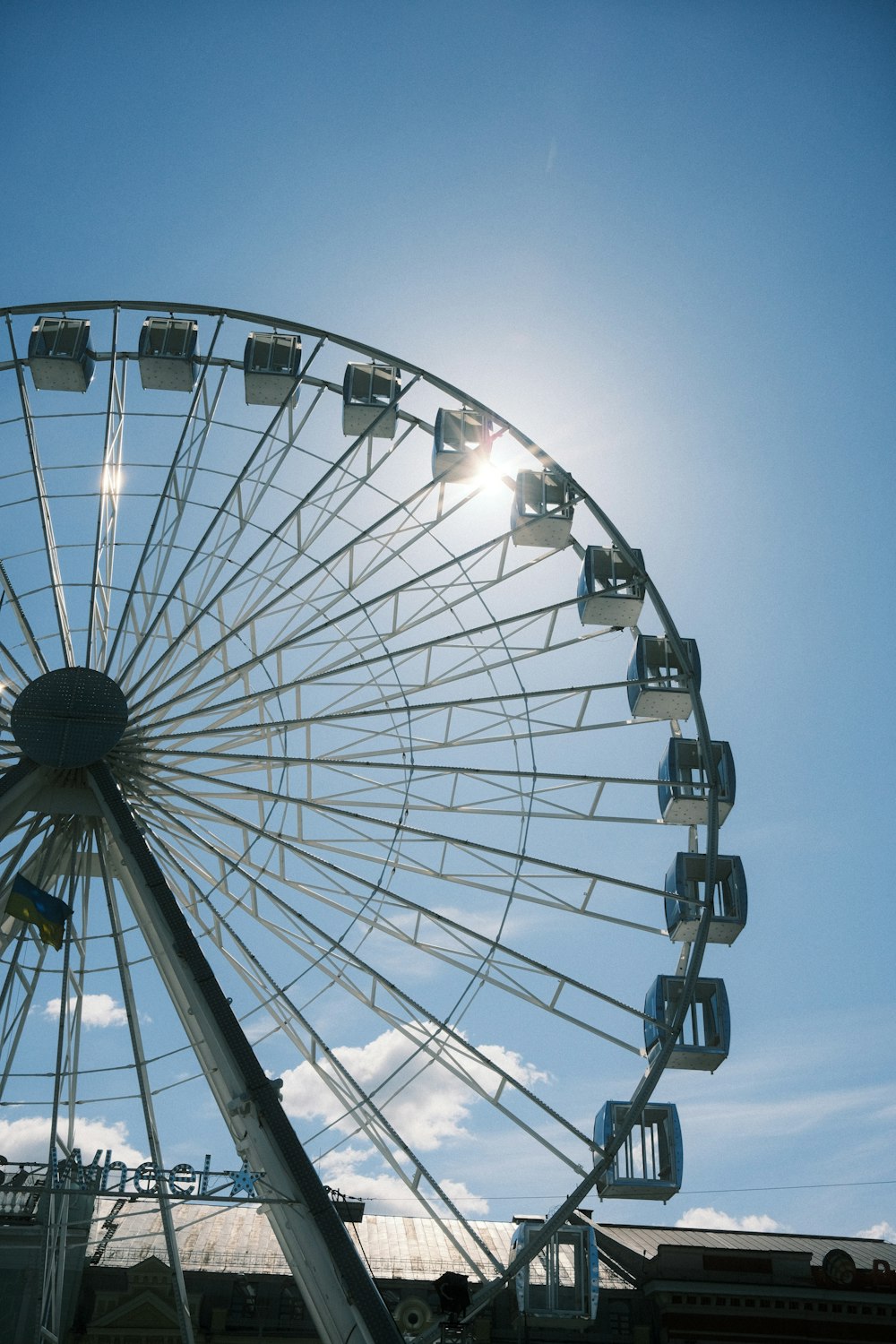 a ferris wheel with the sun in the background
