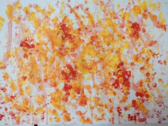 A vibrant yellow and black abstract painting displayed on a minimalist white wall.