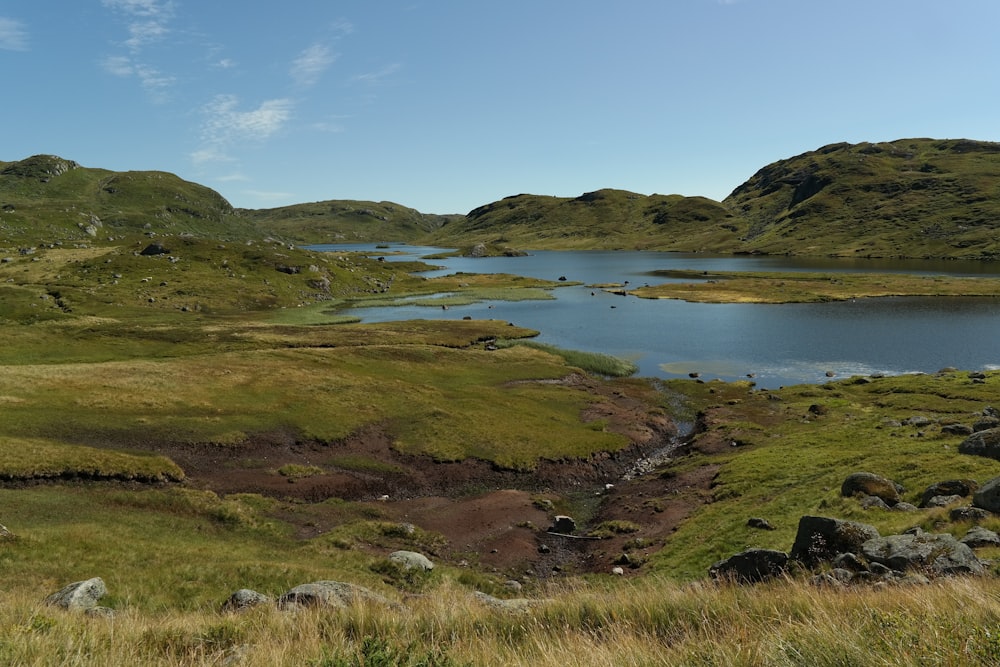 a large body of water surrounded by lush green hills