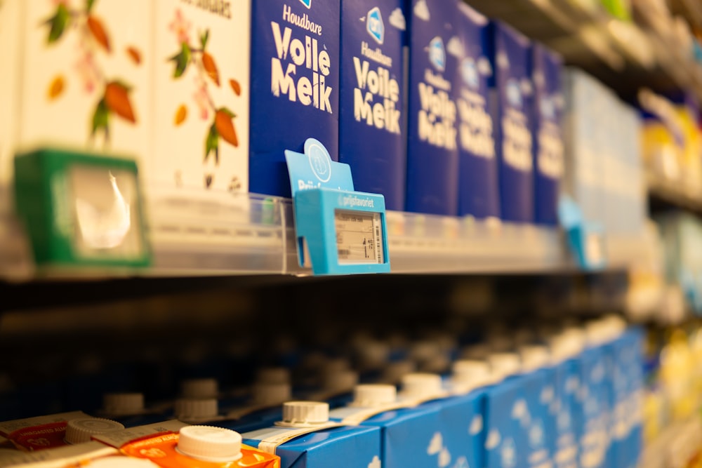 a row of blue and white boxes on a shelf