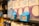 Shelves of milk cartons with blue price tags displaying a price of 1.19 in a grocery store. The focus is on the price tag with surrounding cartons slightly blurred.