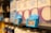 Shelves of milk cartons with blue price tags displaying a price of 1.19 in a grocery store. The focus is on the price tag with surrounding cartons slightly blurred.