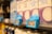 Shelves of milk cartons with blue price tags displaying a price of 1.19 in a grocery store. The focus is on the price tag with surrounding cartons slightly blurred.