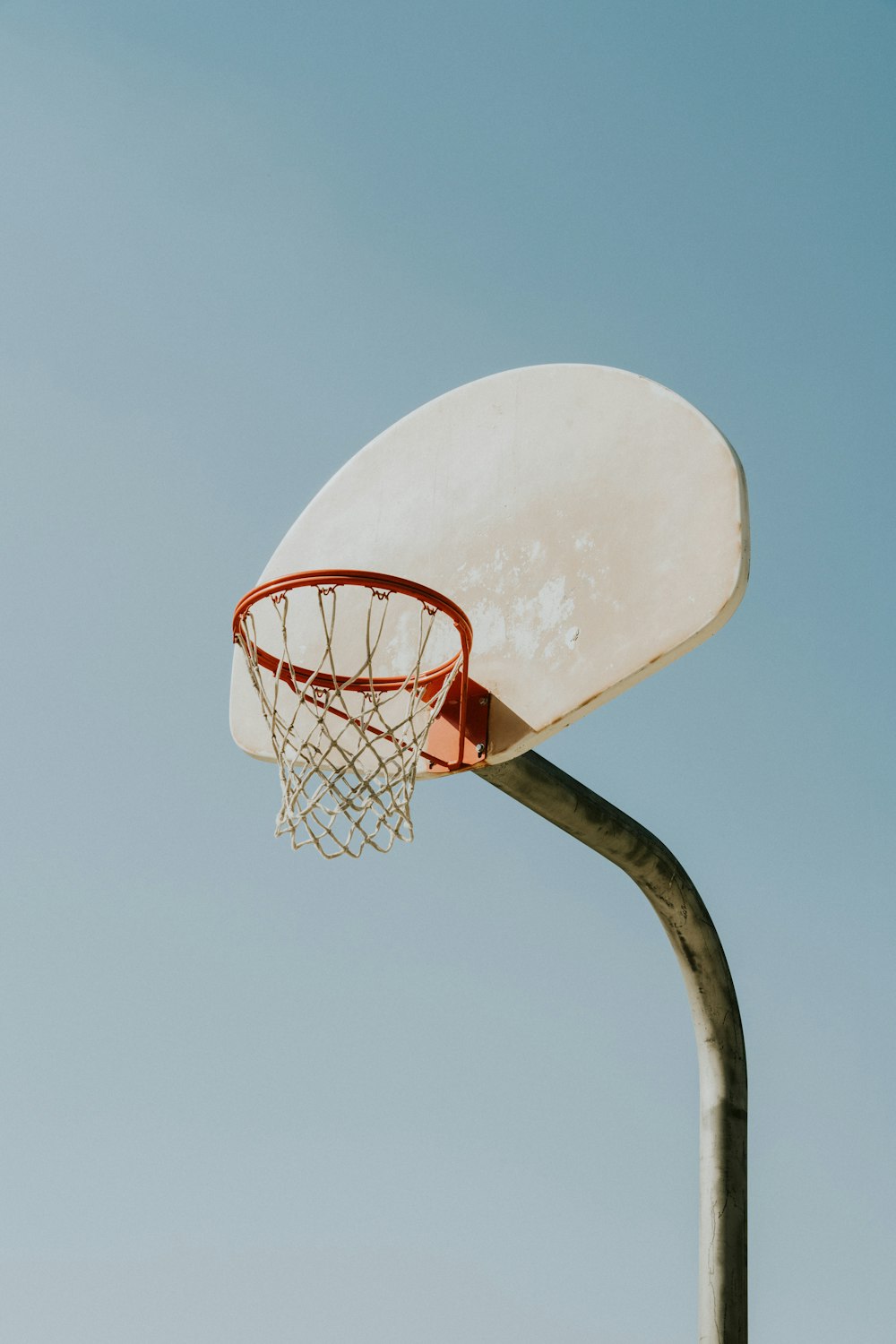 a basketball hoop with a blue sky in the background