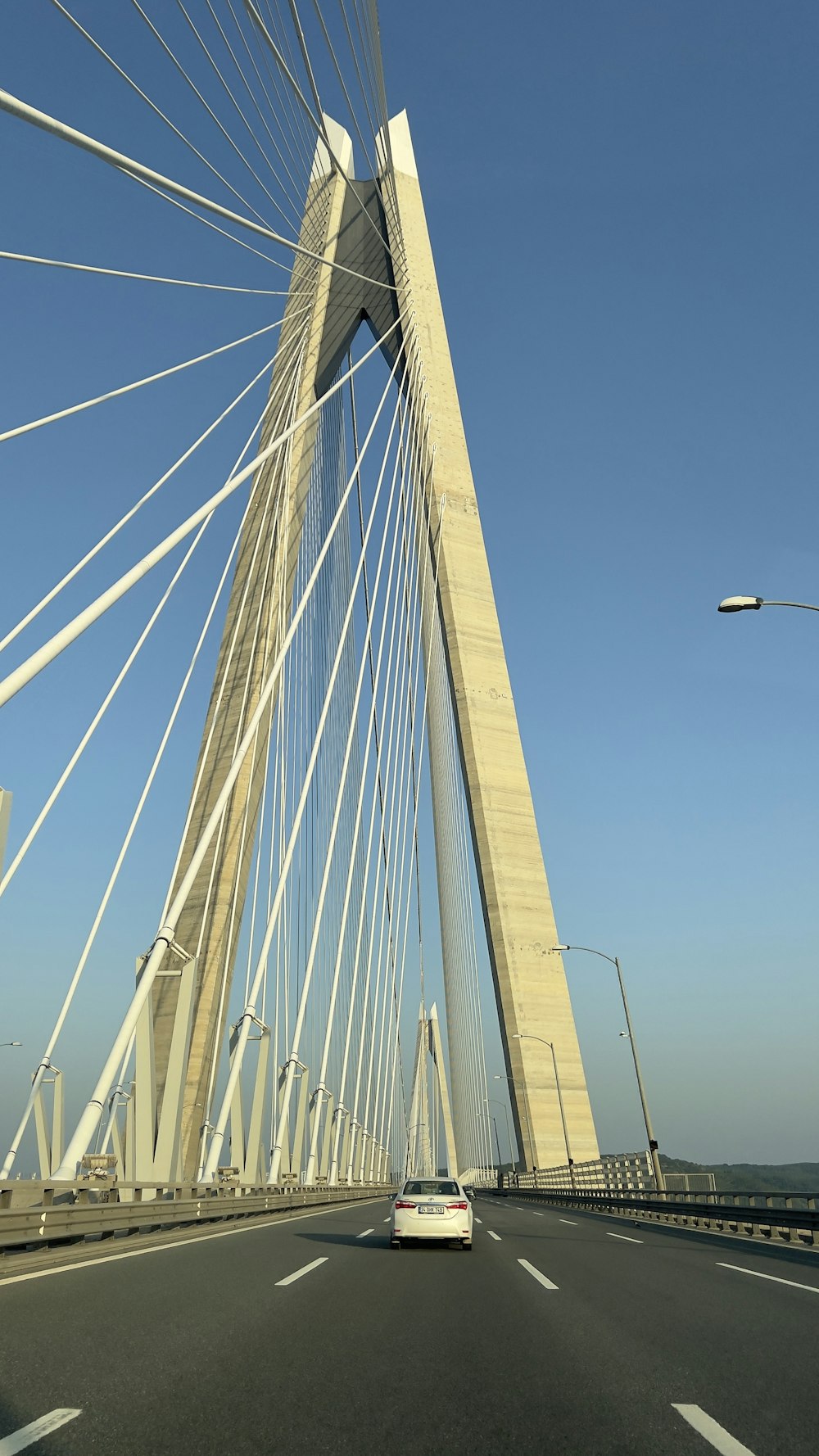 a car driving across a bridge over water