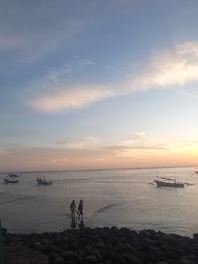 A romantic couple walking hand-in-hand on a serene Kerala backwater boat at sunset.
