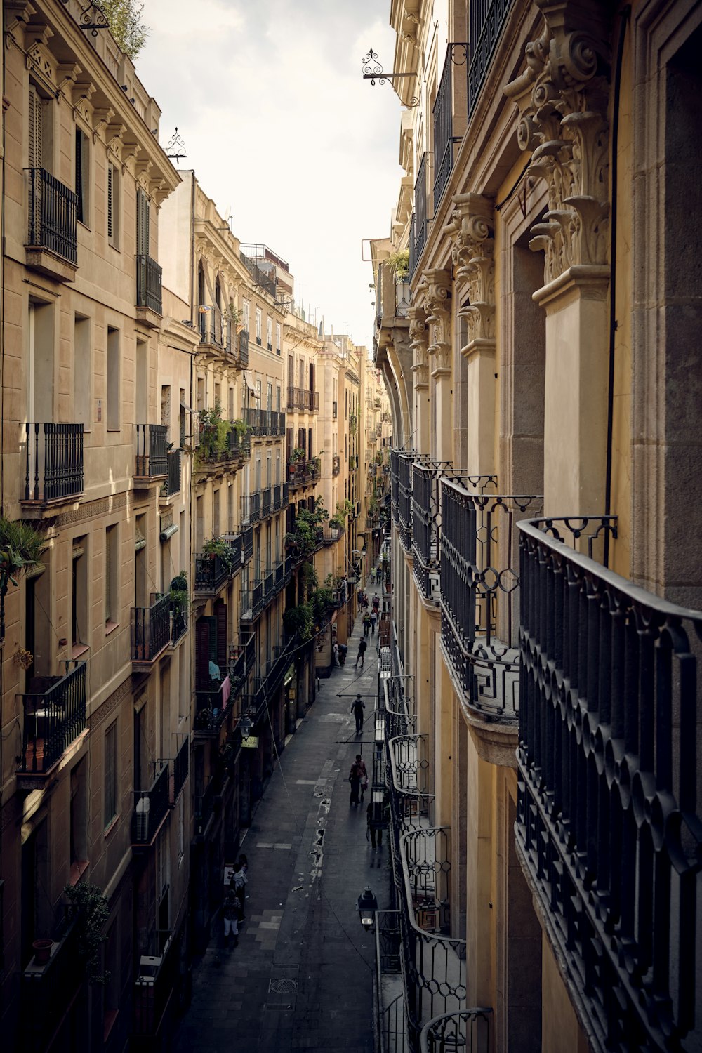 a narrow city street lined with tall buildings