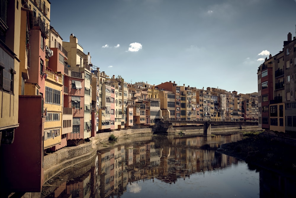 a river running through a city next to tall buildings