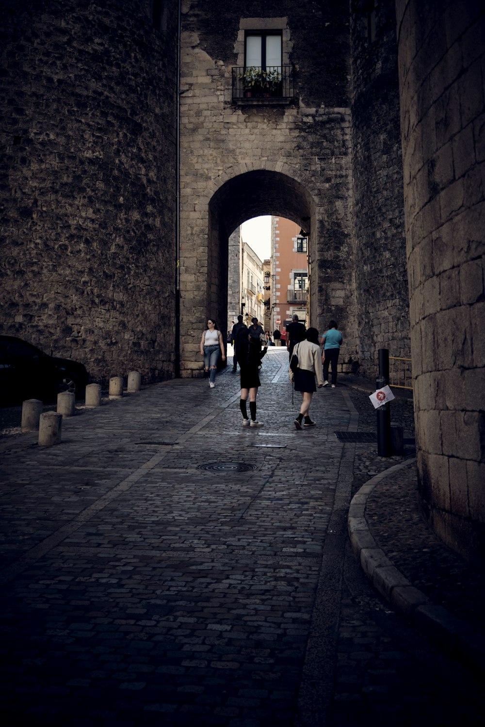 a couple of people that are walking down a street