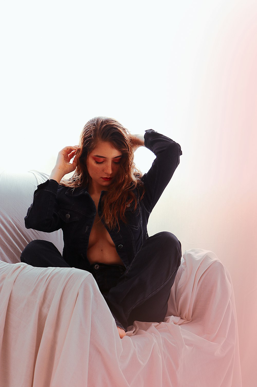 a woman sitting on top of a white couch