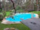 Before and after photo of a backyard pool remodel showcasing sleek decking and elegant paving.