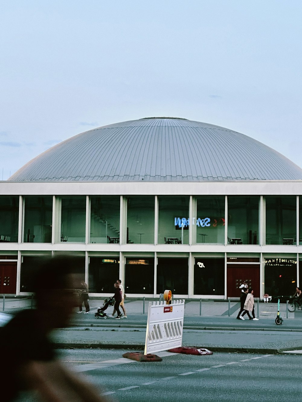 a large building with people walking in front of it