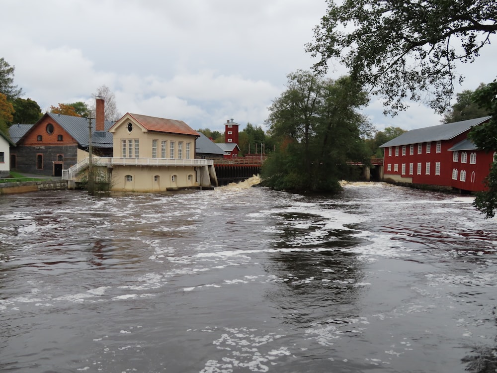 a flooded street with houses and a bridge