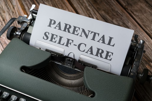 a typewriter with a paper that reads parental self - care