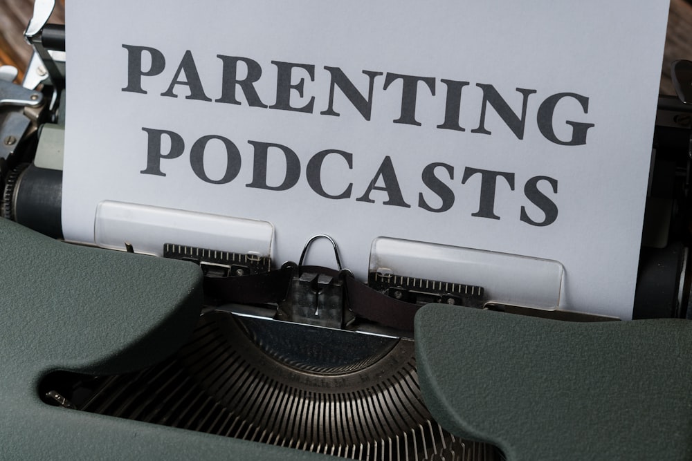 an old typewriter with a paper that reads,'parenting podcasts '