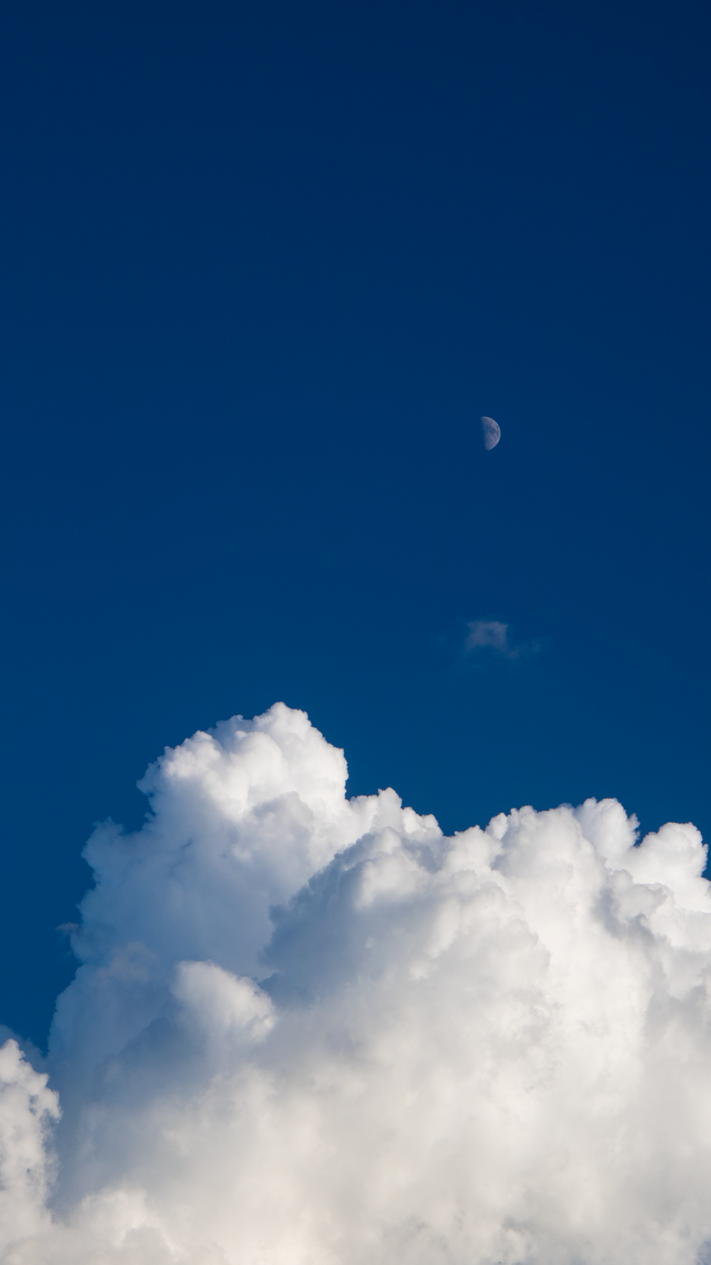 a plane flying through a cloud filled sky