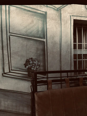 A sleek living room wall adorned with a vibrant 3D floral wallpaper highlighting intricate textures.