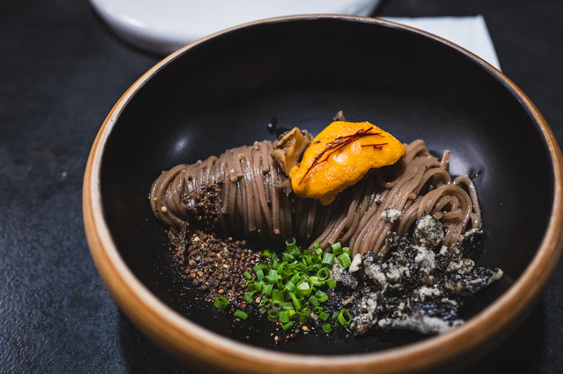 a plate of food on a black table