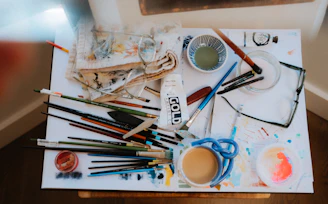 a table topped with lots of art supplies