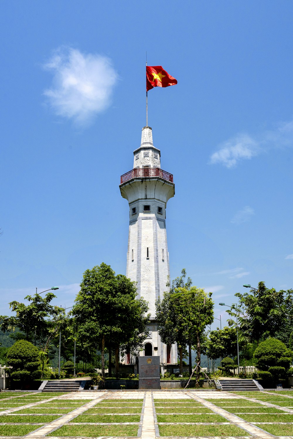 a tall tower with a flag on top of it